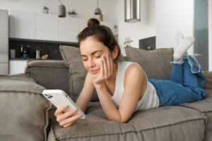 girl looking in phone doom scrolling