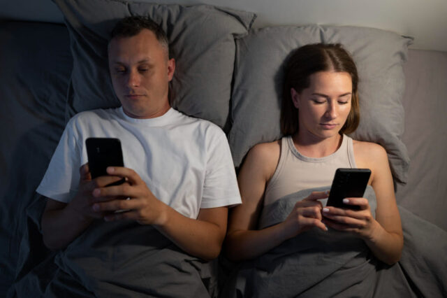 couple using phone at night